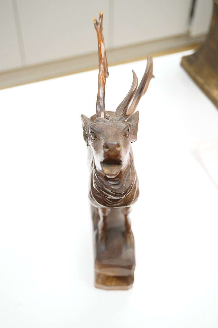 A Swiss Black Forest carving of a roaring stag, 34cm high